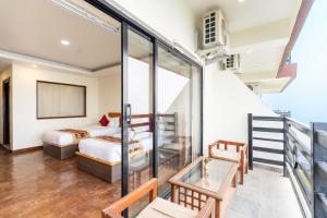 a room with two beds and a balcony at Nagarkot Shangrila Resort in Nagarkot