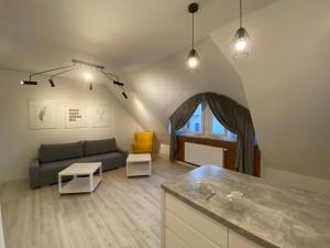 a living room with a couch and a table at Nata&K in Polkowice