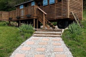 a house with a deck and a walkway at Gîte insolite, logement fabuleux in Guyans-Vennes