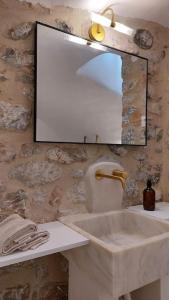 a bathroom with a sink and a mirror at Rafaela 2 floor suite in Pyrgos Dirou +20 photos