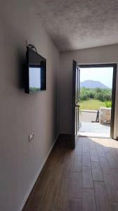 a room with a door and a television on the wall at Rafaela 2 floor suite in Pyrgos Dirou