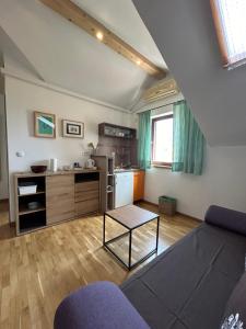 a living room with a couch and a kitchen at Guesthouse Fjaka in Split