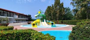 a water park with a slide in a pool at Alexandros Palace in Ouranoupoli
