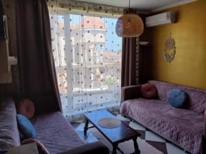 a living room with two couches and a large window at Golden Hacienda in Sozopol +10 photos
