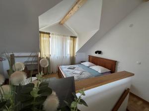 a small bedroom with a bed in a attic at Guesthouse Fjaka in Split