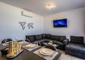 a living room with a table and a couch at Stegna Sea & Sun in Archangelos