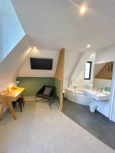 a bathroom with a sink and a toilet and a table at Hotel de France in Saint-Pol-de-Léon +58 photos