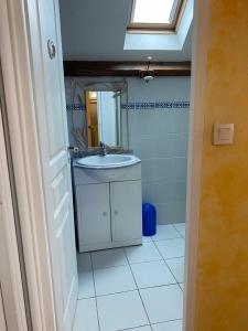 a bathroom with a sink and a mirror at Maison de Charme in Champs-Sur-Marne