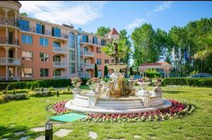 a fountain in a park in front of a building at Golden Hacienda in Sozopol