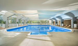 a large swimming pool in a building at Hotel Excelsior - Liburnia in Lovran