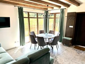 a living room with a table and chairs at Apartamenty Wilcza Knieja in Zawóz