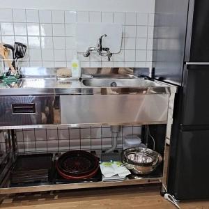 a kitchen with a sink and a counter top at vacation house WAKURA わ蔵 in Tomi