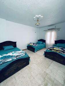 1 dormitorio con 2 camas y techo en شقق وشاليهات بمدينة النورس, en Ismailía
