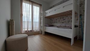 a bedroom with a white bunk bed and a window at Beautiful Bruges in Zeebrugge