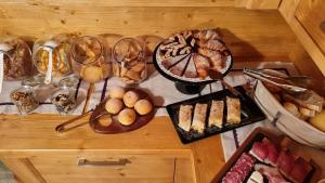 a table topped with lots of different types of food at B&B Casa Nostra in Caderzone Terme