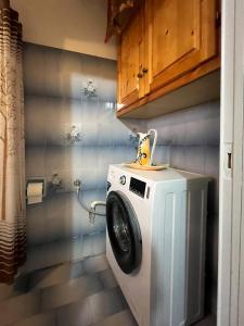 a washer and dryer in a small bathroom at katerina`s house in Kefalos