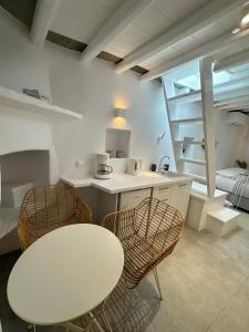 a kitchen with a table and two chairs and a sink at Apollonion house in Apollonia