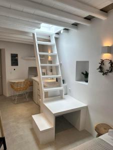 a white staircase in a room with a desk at Apollonion house in Apollonia