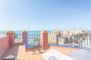 a balcony with a view of the ocean at Wehost-costaluz Casa Guayaba con piscina privada in El Puerto de Santa María