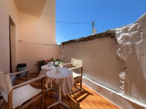 a small table and chairs in a room with a wall at katerina`s house in Kefalos