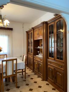 a dining room with wooden cabinets and a table at katerina`s house in Kefalos