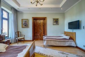 a room with two beds and a flat screen tv at APARTAMENT & SPA Dworski Zakątek in Reda