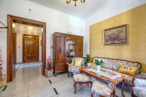 a living room with a couch and a table at APARTAMENT & SPA Dworski Zakątek in Reda
