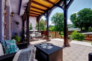 a gazebo with a table on a patio at APARTAMENT & SPA Dworski Zakątek in Reda
