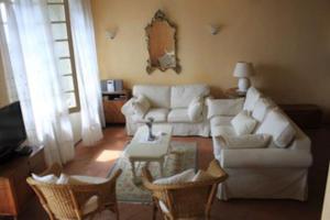 a living room with a white couch and chairs at Villa Paradiso,stunning views ac heated pool in Coreglia Antelminelli