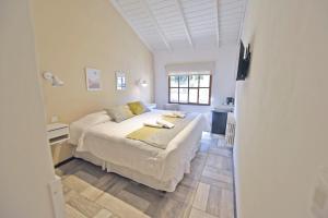 a bedroom with a large bed and a window at Ayres del Filo by Visionnaire in San Martín de los Andes