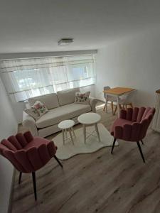 a living room with a couch and two chairs and a table at Apartment around vineyard in Koper