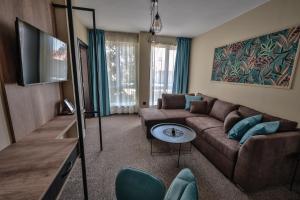 a living room with a couch and a flat screen tv at Villa Martina in Nesebar