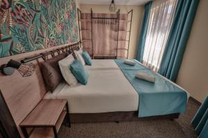 a bedroom with a large bed and a couch at Villa Martina in Nesebar +137 photos