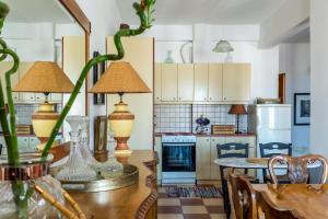 a kitchen with a table with two lamps on it at DROSIA HOME in Skopelos Town