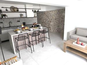 a kitchen with a table and chairs in a room at Valantina's & Mannouel Lardos Luxury Villas in Lardos