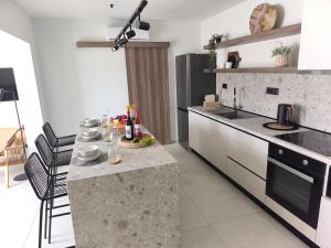 a kitchen with a counter with food on it at Valantina's & Mannouel Lardos Luxury Villas in Lardos
