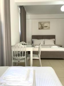 Postel nebo postele na pokoji v ubytování Joni Apartments