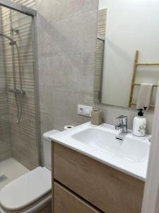 a bathroom with a sink and a shower and a toilet at Casa en el centro de Arahal in El Arahal +25 photos
