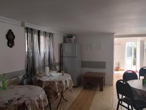 a living room with two tables and a refrigerator at Jesis Batumi in Batumi