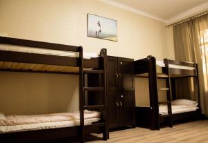 a room with three bunk beds at Hostel Q ,15 хв до жд вокзалу in Lviv