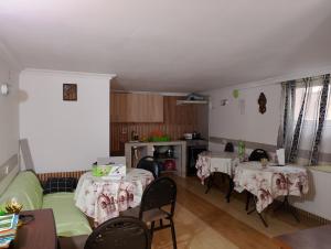 a living room with two tables and a couch and chairs at Jesis Batumi in Batumi +7 photos