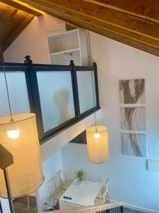 Zimmer mit zwei Hängelampen und einem Tisch in der Unterkunft Casa de Campo Cruz de Pedra in Portomarin