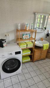 y baño con lavadora y lavamanos. en Ferienwohnung Lehmann en Wolfenbüttel