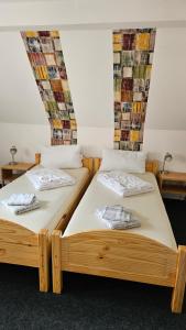 two beds sitting next to each other in a room at Ferienwohnung Lehmann in Wolfenbüttel