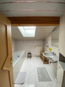 a bathroom with a tub and a sink at Pension Leitenhof in Niederau +84 photos