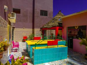 a colorful patio with colorful chairs and a building at Chez Sofia AFRO CHITI in Saint-Louis