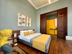 a bedroom with a bed with a yellow and blue at Thirty8 Heritage House in Chania Town