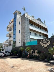 a hotel with a sign on the front of it at Ilio Boutique Hotel in Ksamil