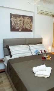 Una cama con dos toallas en una habitación en At Aqua Apartment Athens, en Atenas