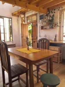een keuken met een houten tafel en stoelen in een kamer bij CASA CIELO in Villa Berna